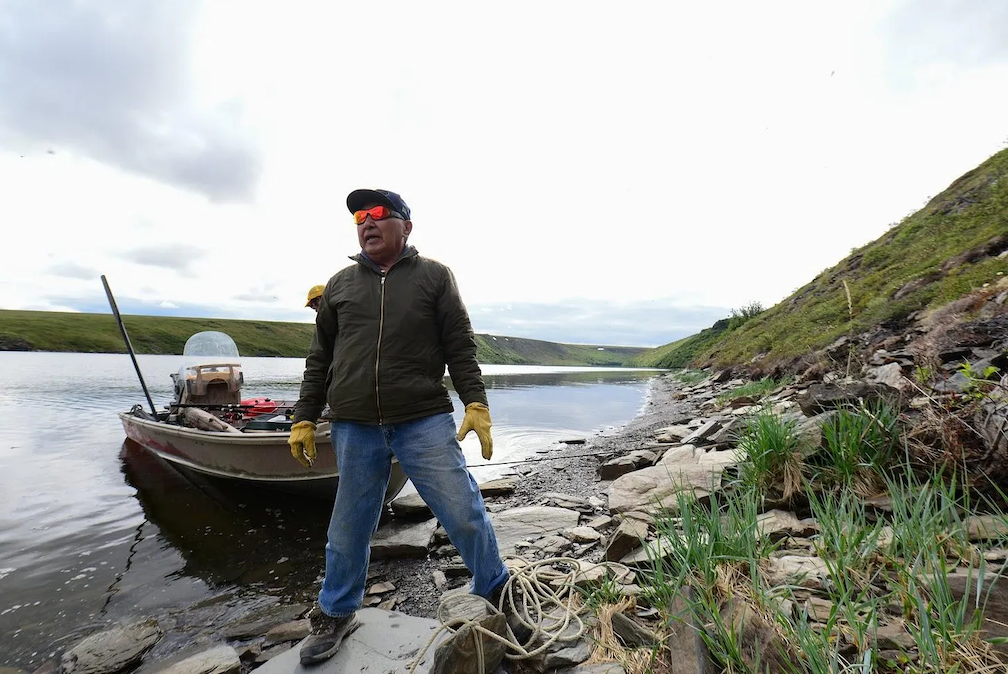 Sylvester Ayek, an Iñupiaq subsistence hunter, fisherman and sculptor, prepares to set his salmon net off the bank of the Tuksuk Channel on the Seward Peninsula. (Photo by Berett Wilber for Northern Journal)