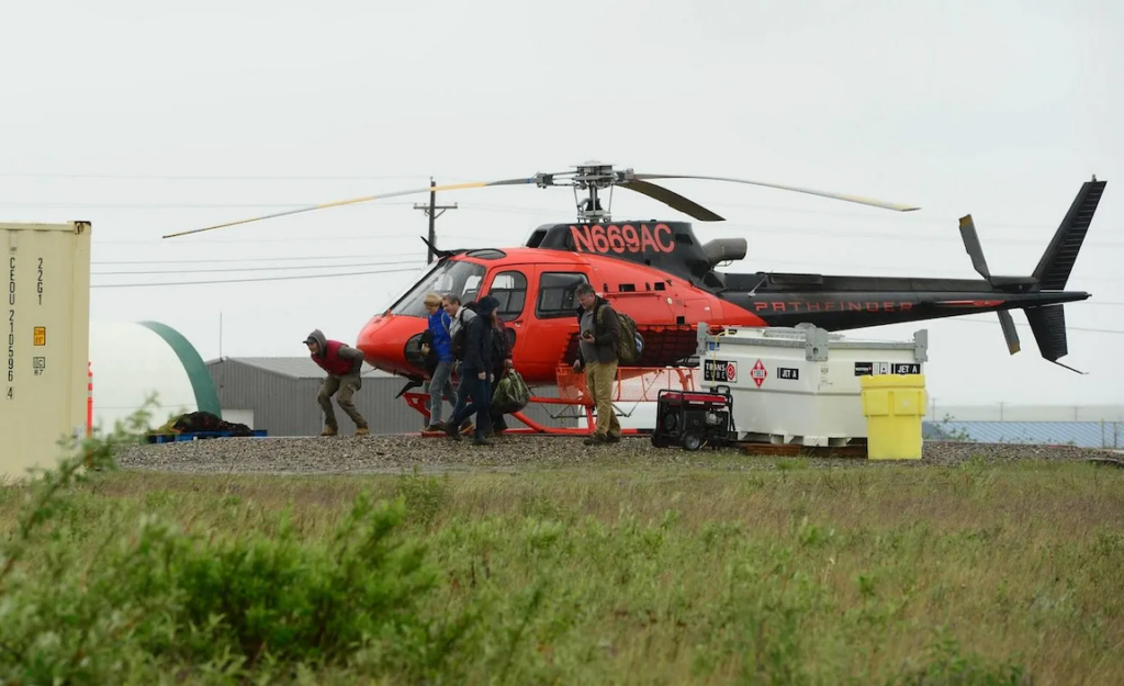 In Nome, U.S. Sen. Lisa Murkowski walks away from a helicopter that flew her to the Graphite One project, a mining exploration camp that the Canadian company is developing to build an open pit graphite mine. (Photo by Berett Wilber for Northern Journal)