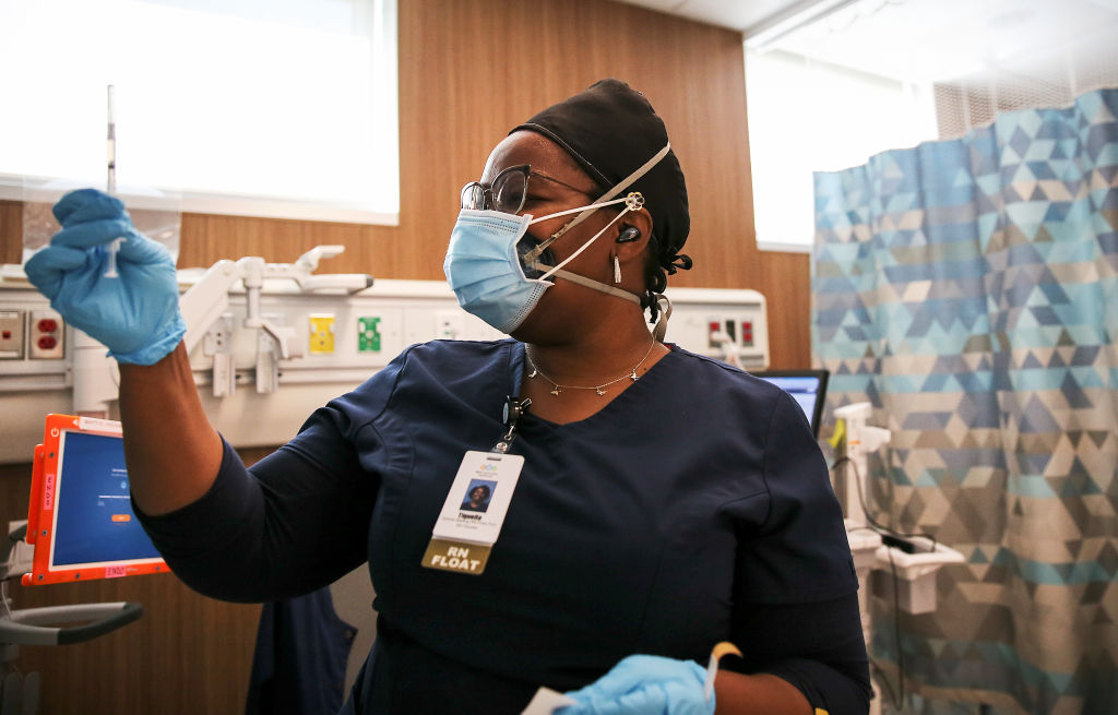 Travel nurse Tiquella Russell of Texas prepares to administer a dose of the COVID-19 vaccine at a clinic at Martin Luther King Jr. Community Hospital in South Los Angeles on February 25, 2021, in Los Angeles, California. (Photo by Mario Tama/Getty Images)