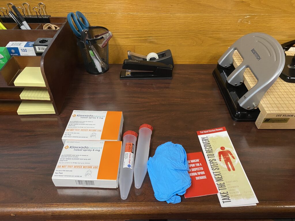 The contents of an opioid overdose kit are displayed on a desk in the Alaska State Capitol on April 3, 2024. (Photo by Claire Stremple/Alaska Beacon)