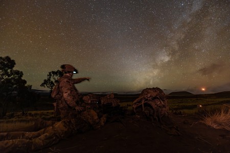 U.S. Army Spc. Collin Hall, assistant gunner, and Spc. Areg Safari, M240 gunner, assigned to Charlie Company, 2nd Battalion, 35th Infantry Regiment, 3rd Infantry Brigade Combat Team, 25th Infantry Division, observe their assigned sector of fire from their defensive fighting position while they wait for the opposing force to attack their defensive positions at the Pohakuloa Training Area, Hawaii, Nov. 9, 2023, during the Joint Pacific Multinational Readiness Center (JPMRC) 24-01 rotation. JPMRC is the Army’s newest Combat Training Center (CTC) and generates readiness in the environments and conditions where our forces will most likely operate. JPMRC 24-01 includes over 5,300 training participants across the U.S. Joint Force, New Zealand, the United Kingdom, Indonesia, and Thailand. (U.S. Army photo by Capt. Angelo Mejia)