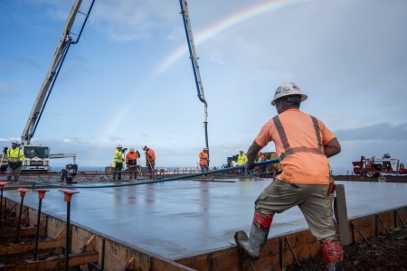 A contractor smooths concrete that is placed in the covered area at the temporary school, Dec. 29, 2023, in Lahaina, Hawaii.

The U.S. Army Corps of Engineers is proceeding with a FEMA mission assignment to support the state of Hawai&#39;i and the state Department of Education to design and oversee the installation of a temporary elementary school campus for the Lahaina community. As of Dec. 23, 2023, the first two rows of classrooms have been set with work commencing on the third row for a total of 20 classrooms and two restrooms set.