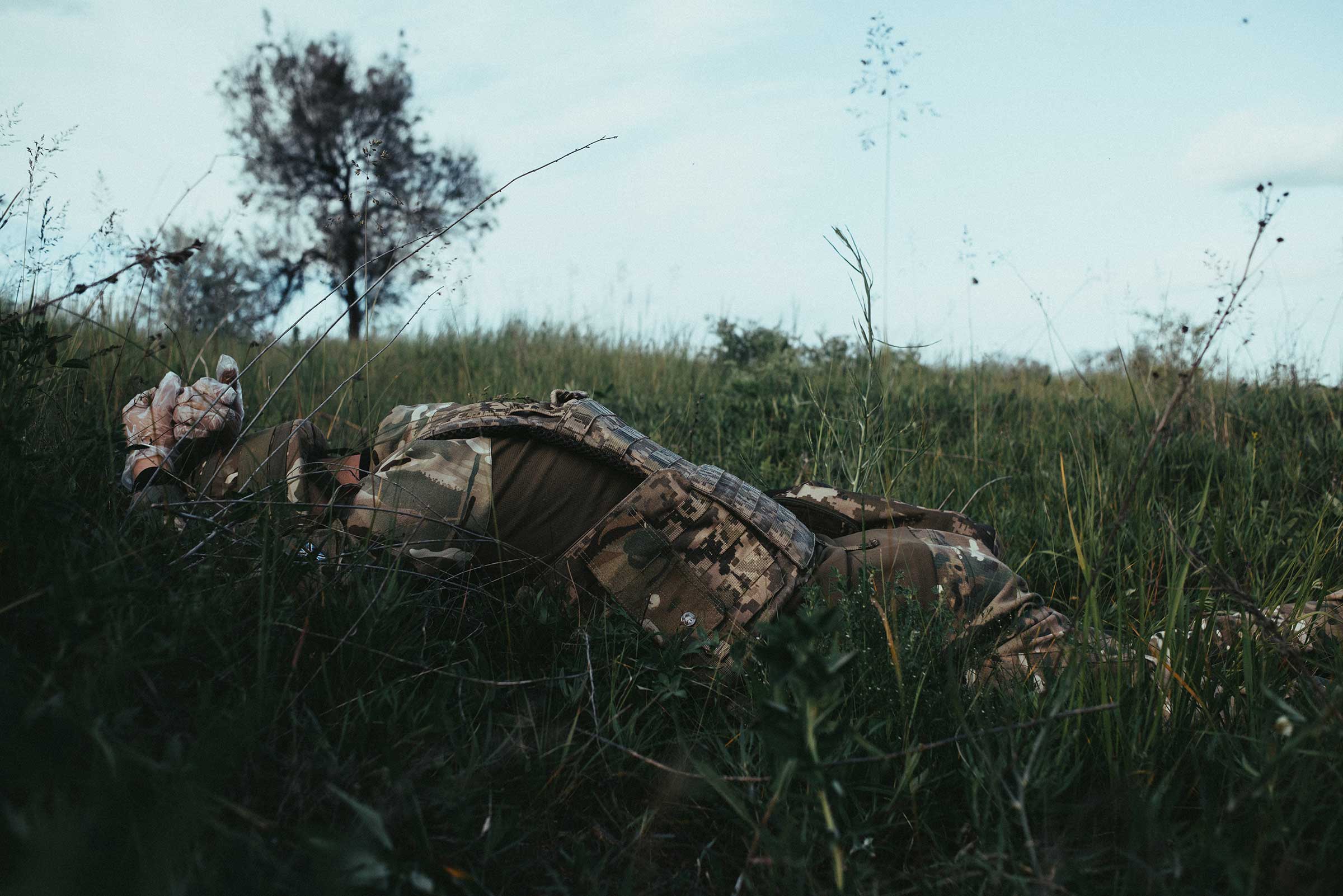 A soldier takes cover during demining near Kharkiv. (Maxim Dondyuk)