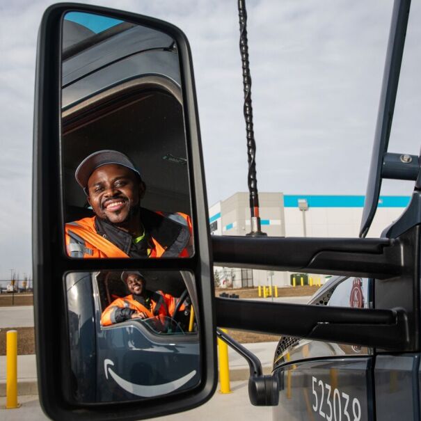 portraits and environmental photos of abel tuyisenge, a transportation operations management associate at amazon, as he drives and inspects trucks