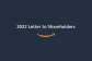 Squid ink color graphic with text that reads: "2022 Letter to Shareholders" with an orange Amazon smile logo underneath. 