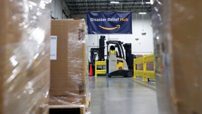 A volunteer helps pack donated supplies at an Amazon fulfillment center to support Hurricane Ian relief