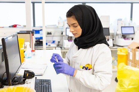 female scientist using a dropper