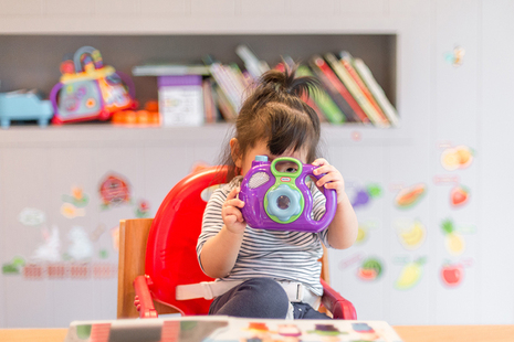 toddler holding toy camera