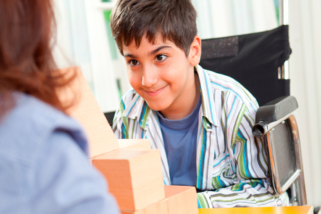 boy in a wheelchair using building blocks