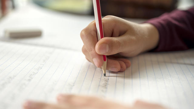 Boy doing his school work or homework 