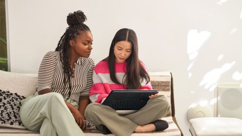 Two young people looking at a laptop