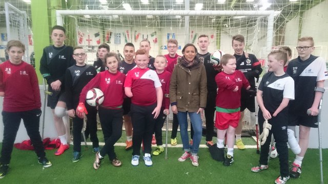 Leah with young amputee football players