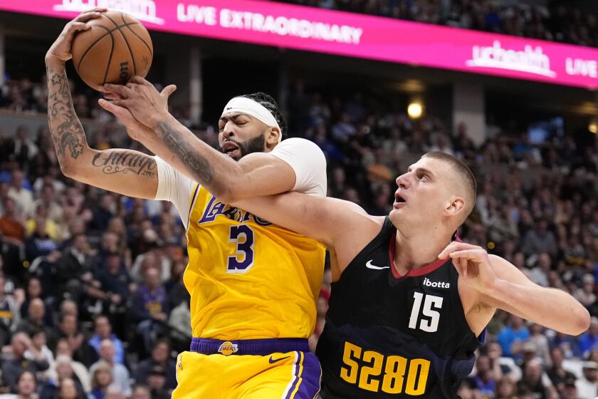 Los Angeles Lakers forward Anthony Davis (3) and Denver Nuggets center Nikola Jokic.
