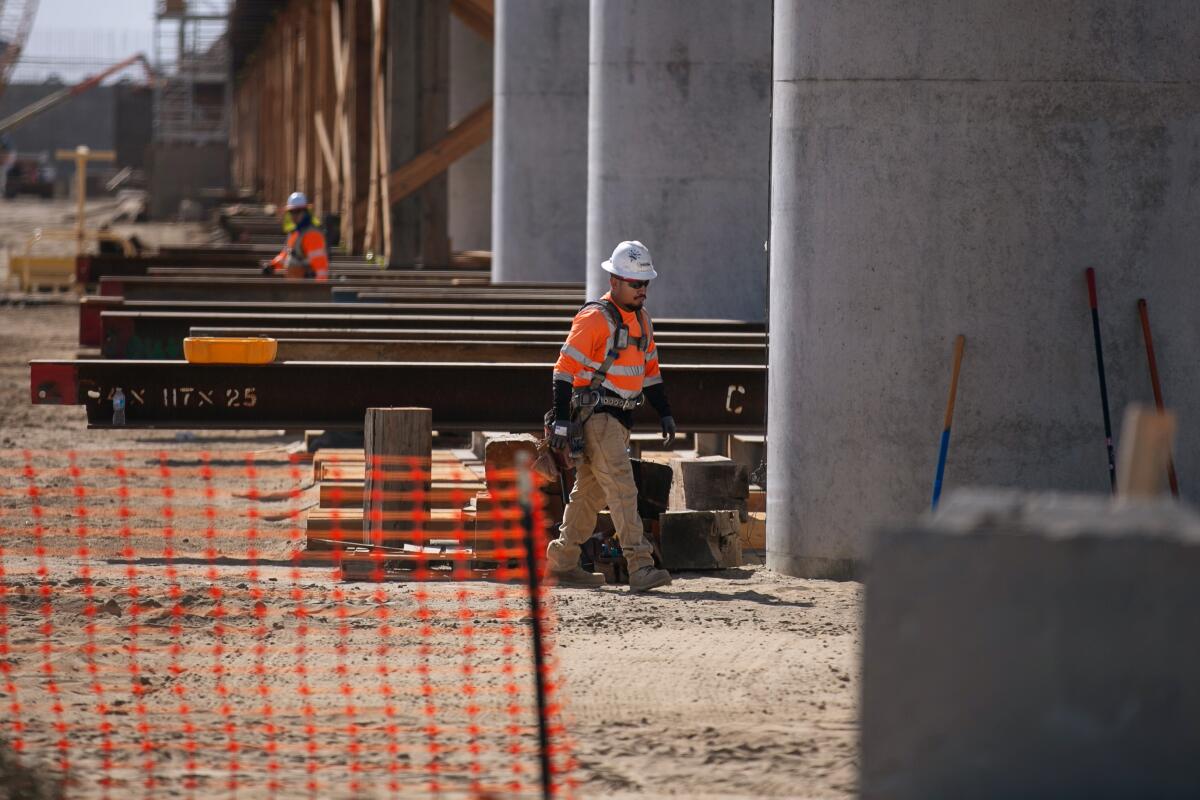 Workers continue construcion on the bullet train portion of the track that runs through central valley farm land in Selma.