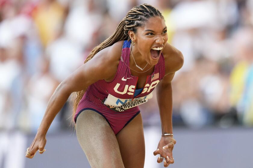 Tara Davis-Woodhall, of the United States, reacts after winning the silver medal in the women's long jump final during the World Athletics Championships in Budapest, Hungary, Sunday, Aug. 20, 2023. (AP Photo/Bernat Armangue)