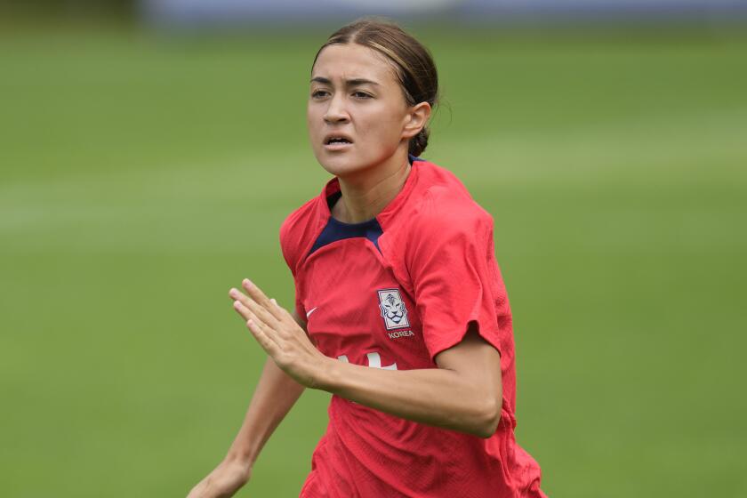 South Korea's women national soccer team player Casey Phair warms up during a training session.