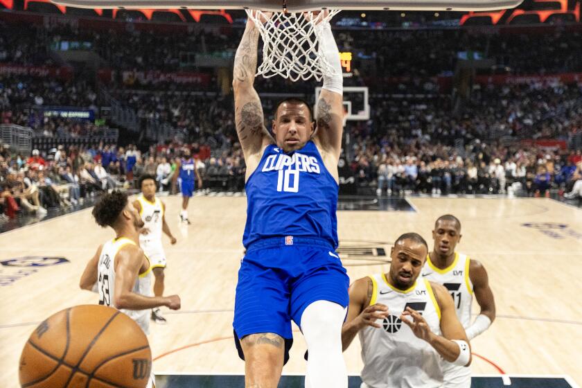 LOS ANGELES, CA - APRIL 5, 2024: LA Clippers center Daniel Theis (10) hangs onto he rm.