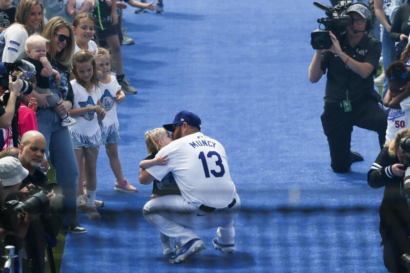 LOS ANGELES, CA - MARCH 28: nLos Angeles Dodgers third baseman Max Muncy (13) is introduced before the game against the St. Louis Cardinals in Dodgers Stadium on Thursday, March 28, 2024 in Los Angeles, CA. (Robert Gauthier / Los Angeles Times)