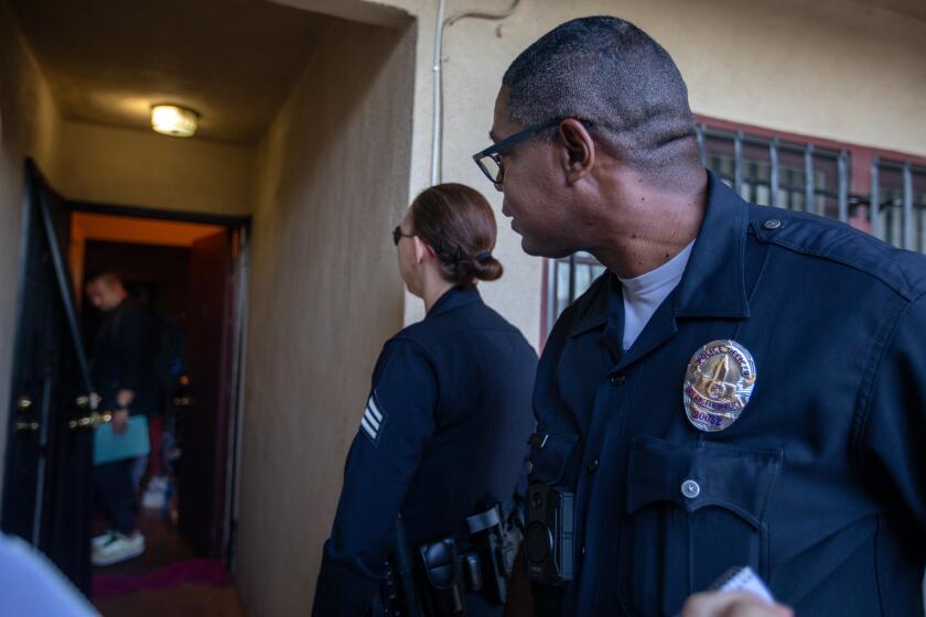 Los Angeles, CA - July 20: A mother called in for assistance to help her son with having mental health issues. The Mobil Crisis Outreach Team (MCOT) went to the home on Thursday, July 20, 2023, in Los Angeles, CA. Officers from the Los Angeles Police Department were on hand to support the team. The MCOT team asked the officer the wait outside the door in an effort not to escalate the situation. (Francine Orr / Los Angeles Times)