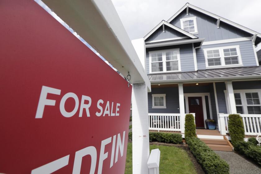 FILE - In this April 1, 2020 photo, a "For Sale" sign stands in front of a home that is in the process of being sold in Monroe, Wash., outside of Seattle. Americans stepped up their home purchases in June, clawing back some of the losses after the pandemic had caused sales to crater in the prior three months. (AP Photo/Elaine Thompson, File)