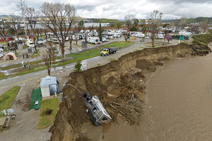CASTAIC, CA - FEBRUARY 27: A recreational vehicle lays at the bottom of a cliff in the Santa Clara River at Valencia Travel Village RV Resort in Castaic, CA on Monday, Feb. 27, 2023. The damage was caused by the previous storm. The weather forecast calls for a few more days of rain. (Myung J. Chun / Los Angeles Times)