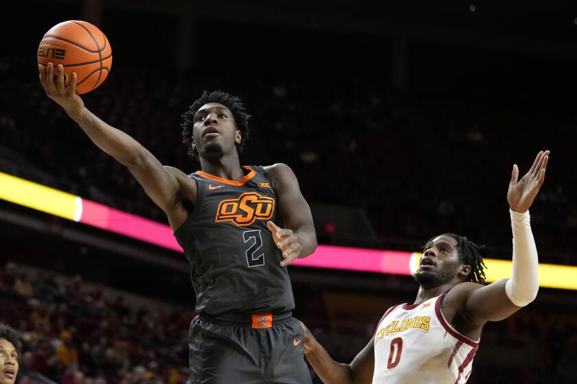 Oklahoma State forward Eric Dailey Jr. (2) drives to the basket.