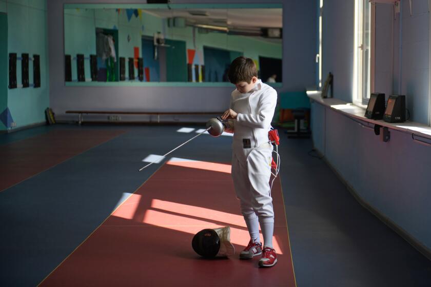 Kharkiv, Ukraine-April 10, 2024-Children practice fencing in the absence of light at the Unifecht sports complex, which has been repeatedly targeted by Russian missiles. (Olga Ivashchenko for the Times)