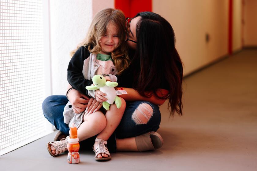 Sun Valley, CA - April 10: Anica Rubana poses for a portrait with her daughter Faith Leon, 3, at Sun King Apartments, a housing project created for homeless families with LAUSD students to improve their daily lives in a common area on Wednesday, April 10, 2024 in Sun Valley, CA. (Dania Maxwell / Los Angeles Times)