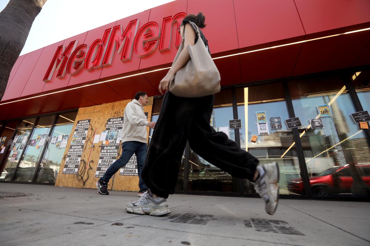 Pedestrians walk past the now-closed MedMen cannabis store on Abbot Kinney Boulevard in Venice.