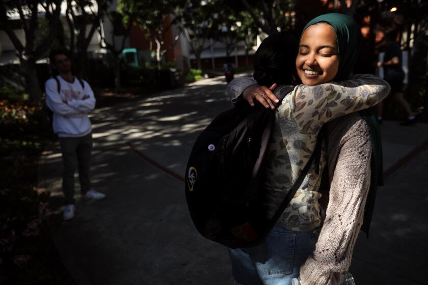 LOS ANGELES, CA - APRIL 16, 2024 - Asna Tabassum, facing, a graduating senior at USC, receives a hug of support from a friend on the USC campus on April 16, 2024. Tabassum was selected as valedictorian and offered a traditional slot to speak at the 2024 graduation. After on-and-off campus groups criticized the decision and the university said it received threats, it pulled her from the graduation speakers schedule. (Genaro Molina/Los Angeles Times)