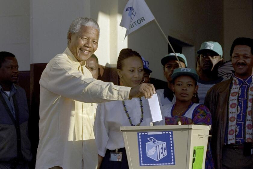 FILE - Then African National Congress leader, Nelson Mandela casts his vote April 27, 1994 near Durban, South Africa, in the country's first all-race elections. South Africans celebrate "Freedom Day" every April 27, when they remember their country's pivotal first democratic elections in 1994 that announced the official end of the racial segregation and oppression of apartheid. (AP Photo/John Parkin. File)