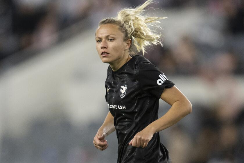 Angel City FC forward Claire Emslie (10) runs during an NWSL soccer match.