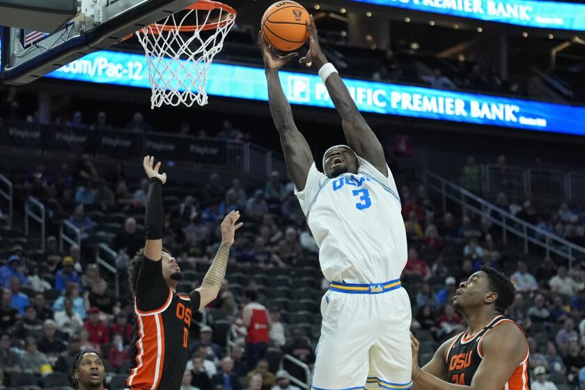 UCLA forward Adem Bona (3) dunks over Oregon State during the first half of an NCAA college basketball game in the first round of the Pac-12 tournament Wednesday, March 13, 2024, in Las Vegas. (AP Photo/John Locher)