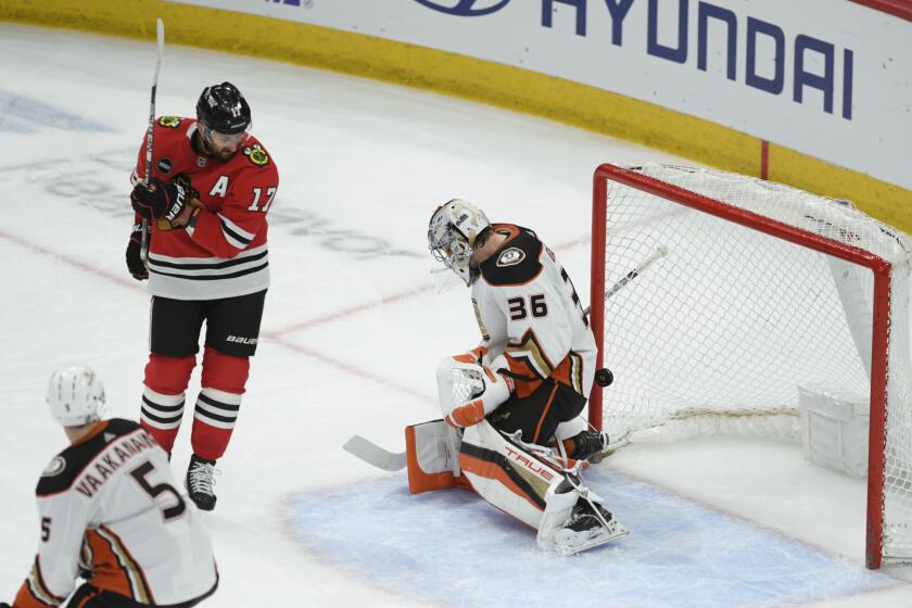 Chicago Blackhawks' Nick Foligno (17) watches teammate Seth Jones' goal go past Anaheim Ducks goalie John Gibson (36) during the second period of an NHL hockey game Tuesday, March 12, 2024, in Chicago. (AP Photo/Paul Beaty)