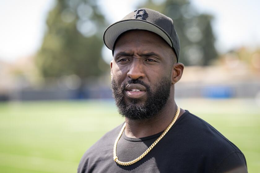 UCLA coach Deshaun Foster talks with the reporters after the program's Pro Day. 