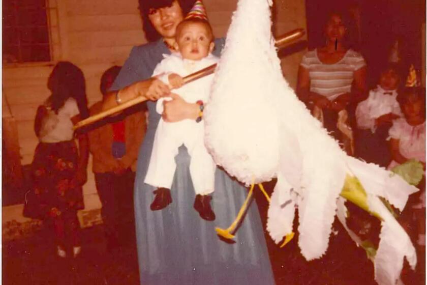 Gustavo and mom on the day of his christening in a family photo.