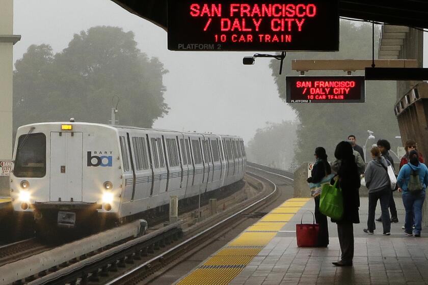 FILE - Bay Area Rapid Transit passengers wait for a train in this Oct. 22, 2013 file photo taken in Oakland, Calif. San Francisco Bay Area Rapid Transit's contract with its two largest unions appears to be facing uncertainty late Friday Nov. 15, 2013 as the agency called for a return to the bargaining table, just weeks after the agreement settled a dispute that has already caused two strikes. (AP Photo/Ben Margot, File)