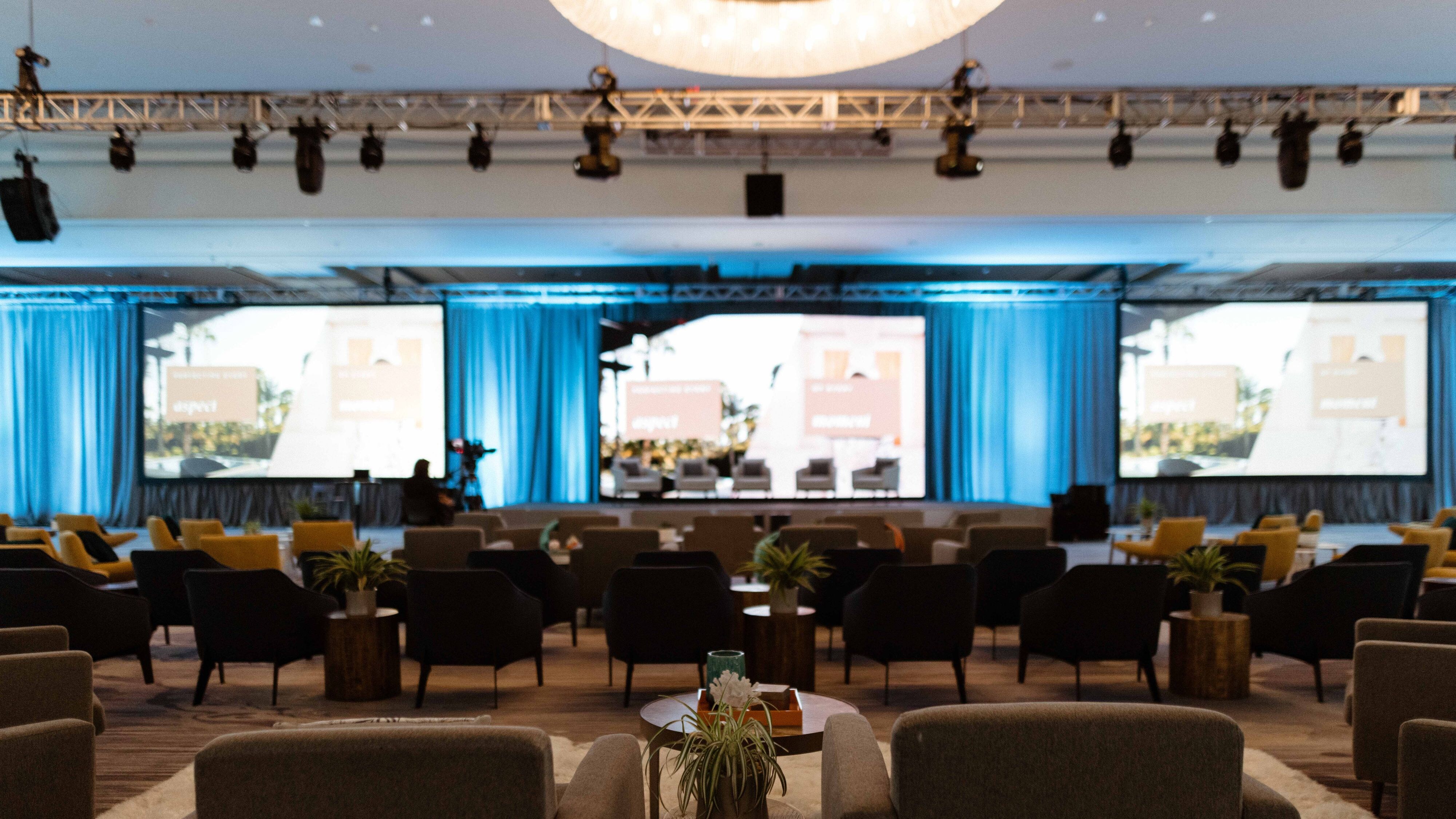 A spacious meeting room with chairs and monitors