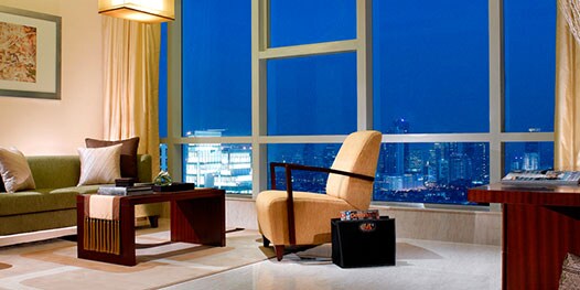 Apartment living room overlooking city at night