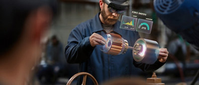 Man using augmented reality interface while working on a mechanical part.