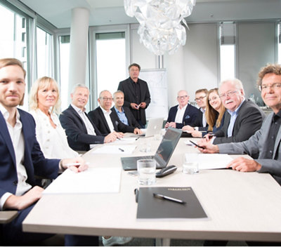 A group of people gathered around a table in a meeting room.