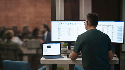 A person sitting at a desk with a computer and a computer