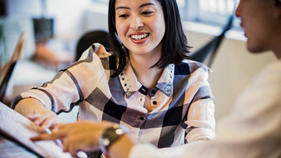 A girl smiling at a computer