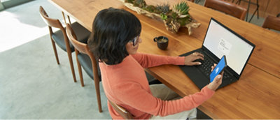 A person sitting at a table using a computer