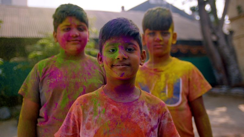 History and observance of Holi, Hindu festival celebrated in February-March. Participants throw colored water and powder on each other. Hinduism, Krishna. Holiday.