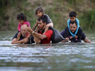 Migrants cross the Rio Grande in Eagle Pass, Texas, the United States on July 25, 2022.  Immigrants immigration border crisis U.S and Mexico river