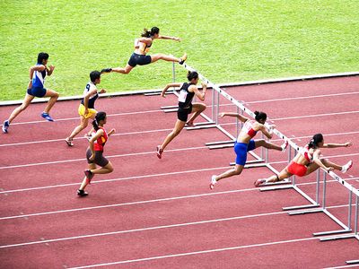 Men jumping hurdles (track sport; athletics; athlete)