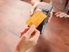 Person paying with a credit card using a credit card terminal. Cashless payment, credit card reader