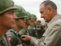 Vietnam War. U.S. President Lyndon B. Johnson awards the Distinguished Service Cross to First Lieutenant Marty A. Hammer, during a visit to military personnel, Cam Ranh Bay, South Vietnam, October 26, 1966. President Johnson