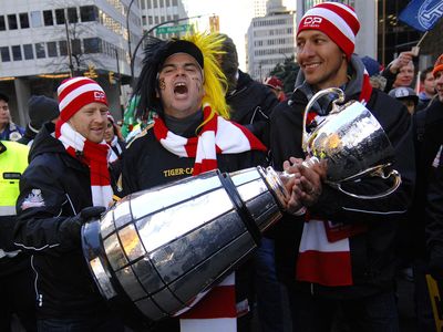 VANCOUVER, CANADA - NOVEMBER 11, 2011: Football fans arrive to BC Place to watch BC Lions playing in Grey Cup finals in Vancouver, Canada, on November 11, 2011.